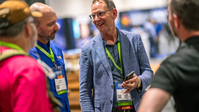 Two reliability industry professionals talking together during a Reliable Plant conference.