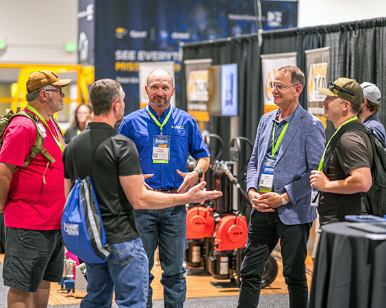 Maintenance and reliability professionals networking together on a Reliable Plant exhibition floor.
